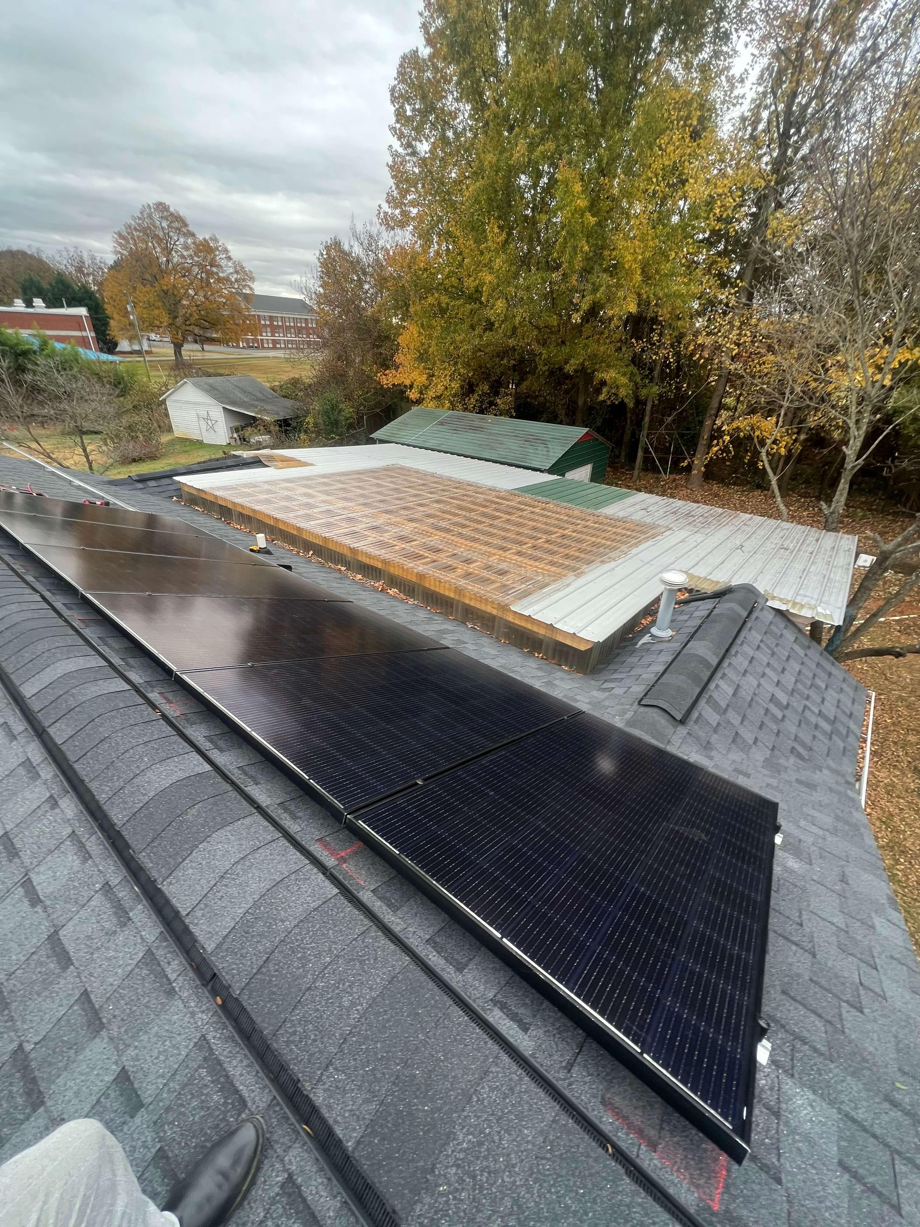 Top down view of solar panels on a roof on a sunny day